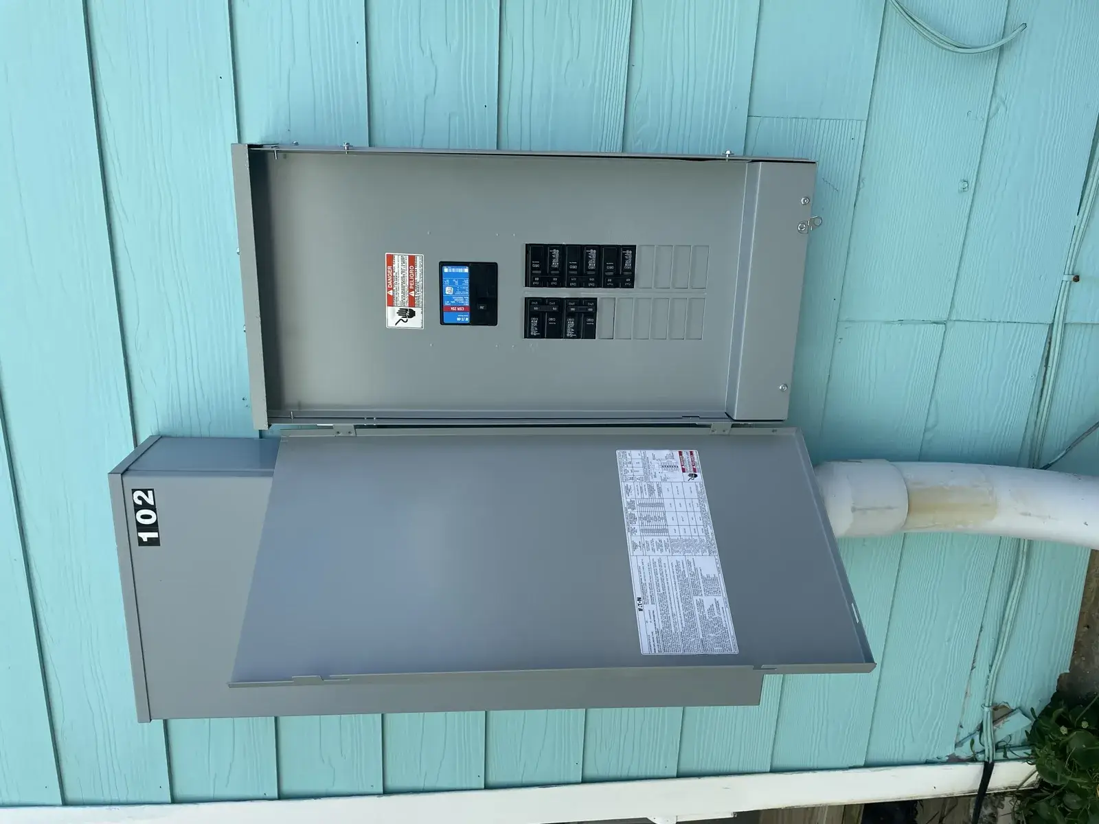 Exterior electrical service on a coastal Baldwin County home, with raised beach houses behind it