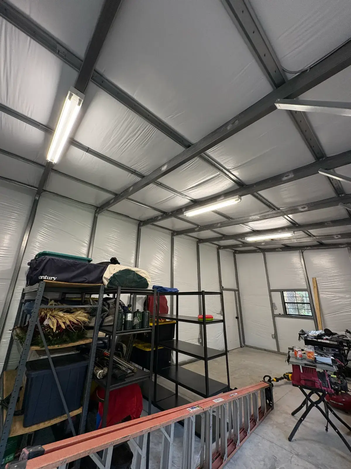 LED strip fixtures installed in a metal shop building interior by Wave Electric