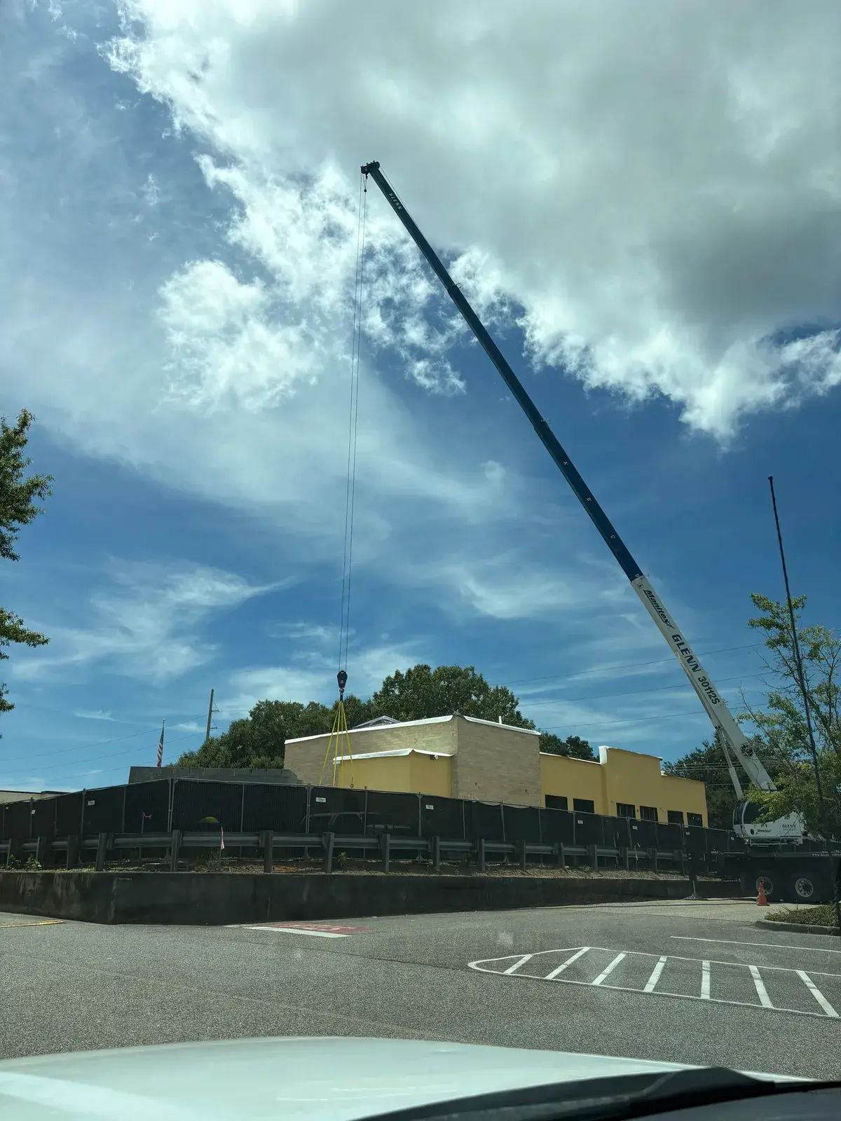 Parking lot light pole being set on a commercial job in Baldwin County