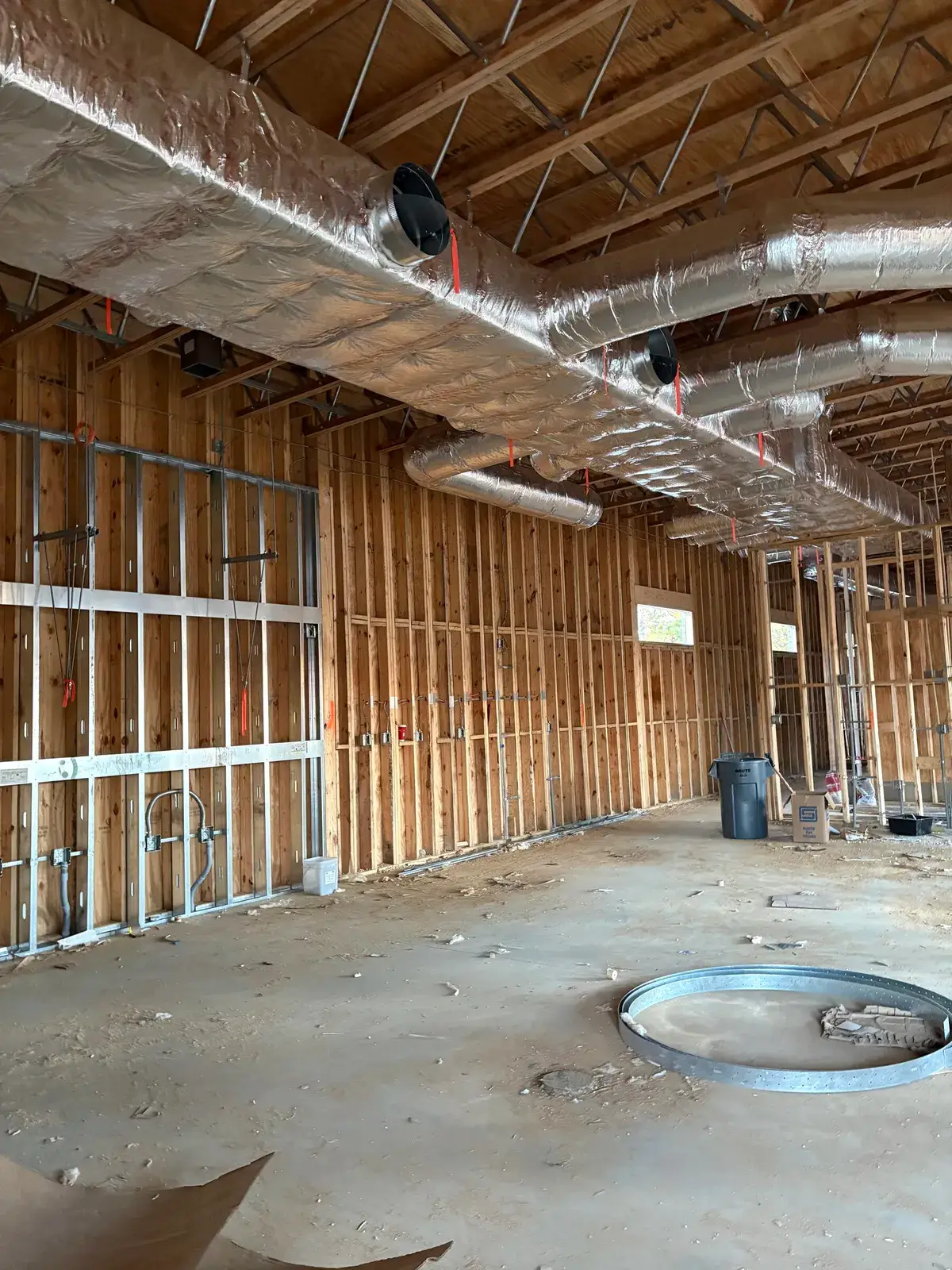 Electrical rough-in with EMT conduit and boxes set inside a Fairhope restaurant before drywall