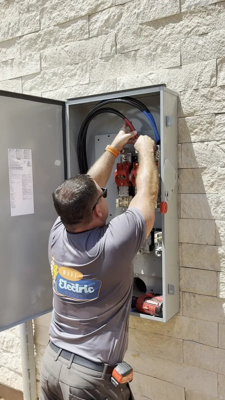 Jimmy of Wave Electric working inside an electrical panel